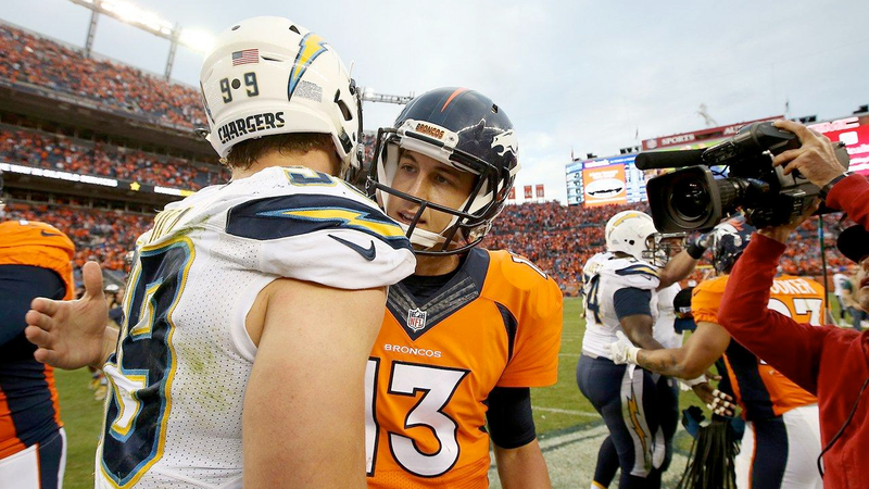 San Diego Chargers defensive end Joey Bosa shares a bro hug with Denver Broncos quarterback Trevor Siemian (Photo: Eric Bakke/Denver Broncos)